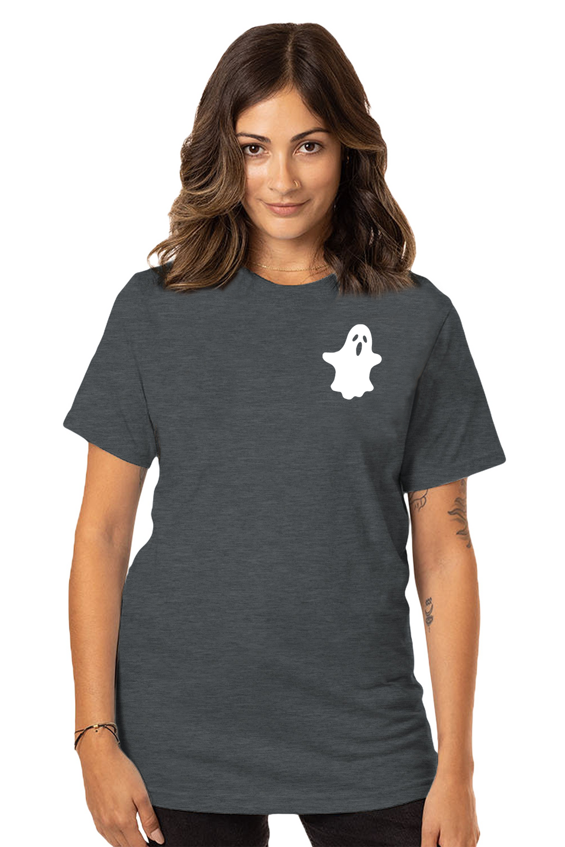A woman wearing a gray crew neck t-shirt with a white ghost graphic on the front left shoulder, paired with black leggings