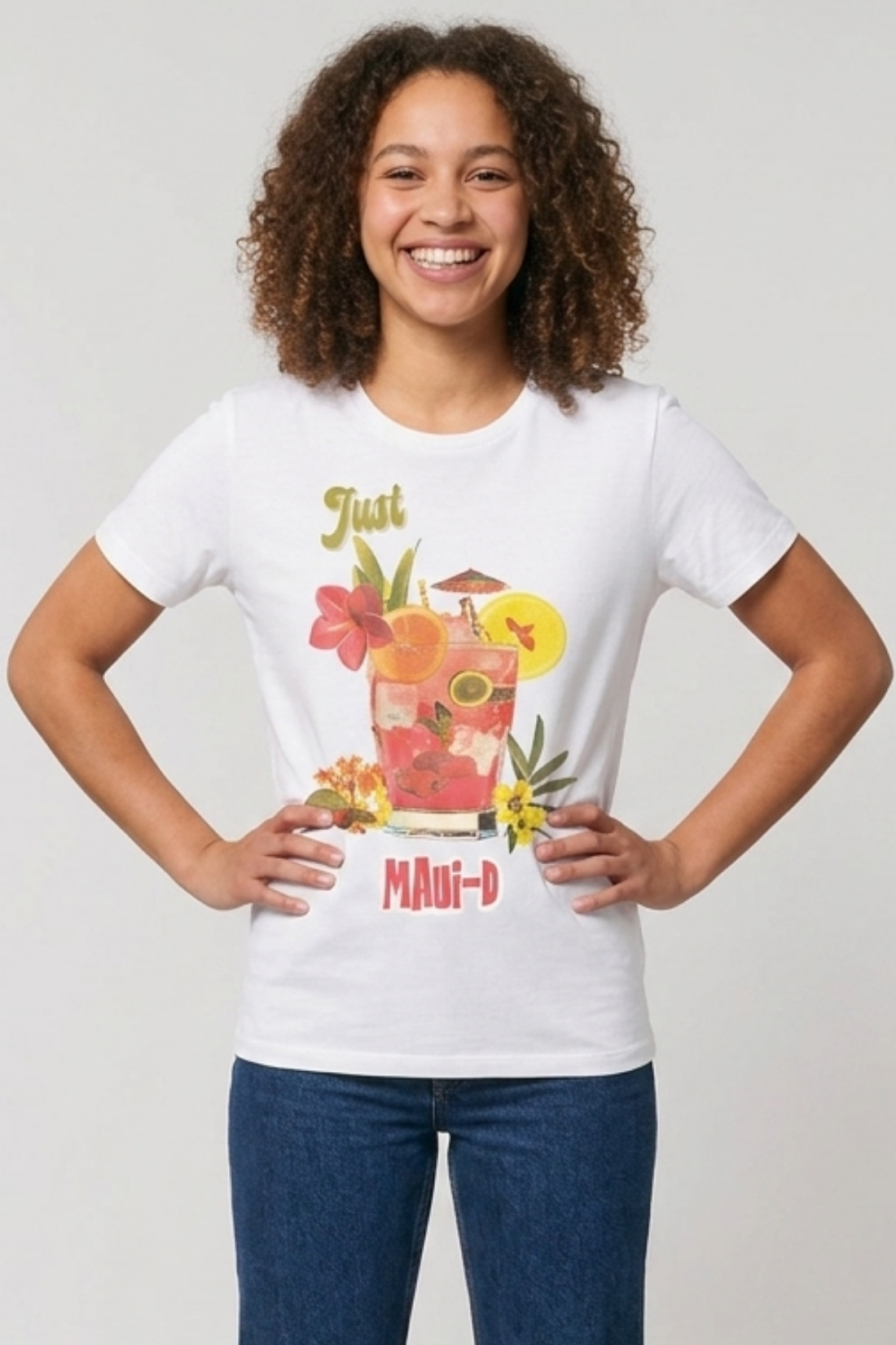 Woman wearing a white t-shirt with a colorful graphic and "Just Maui-D" text, standing against a plain background.