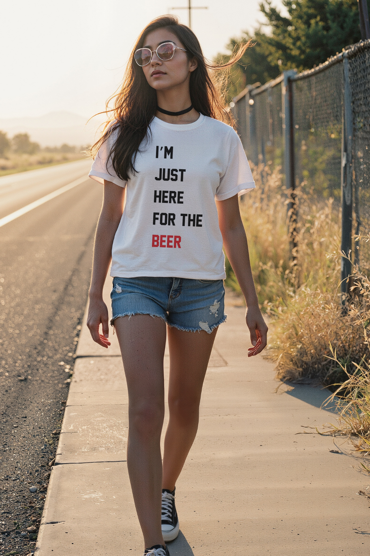 Woman walking on a road wearing a white t-shirt with &