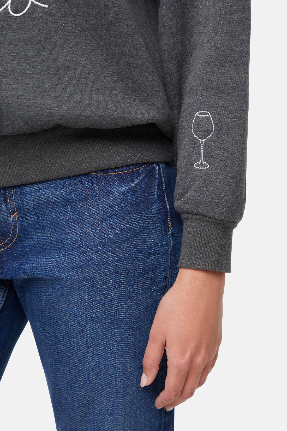 Gray sweatshirt with a white wine glass design above left hem sleeve on a plain background