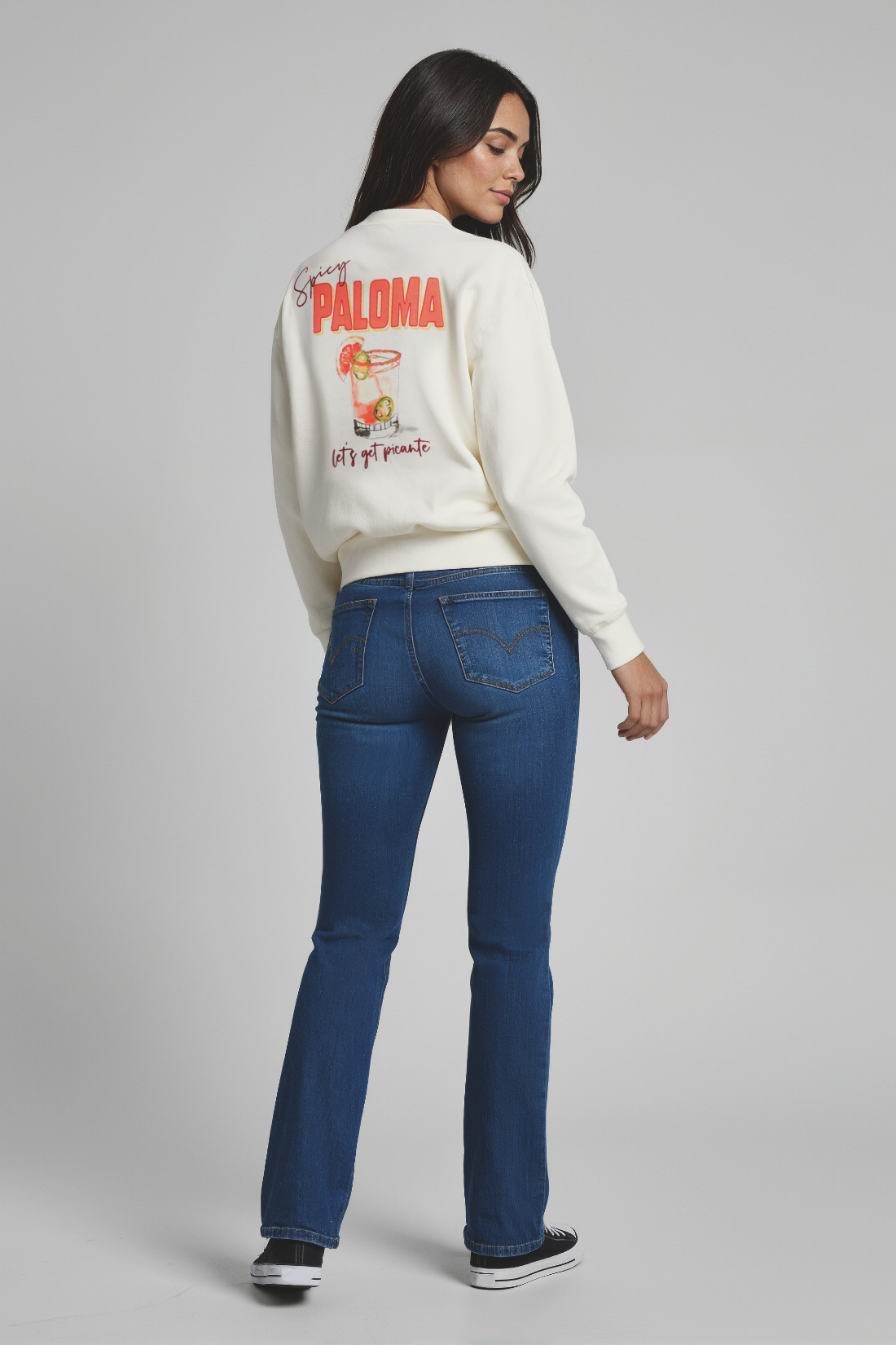 Woman wearing a white sweatshirt with &