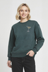Woman wearing a green sweatshirt with a martini glass design on a white background
