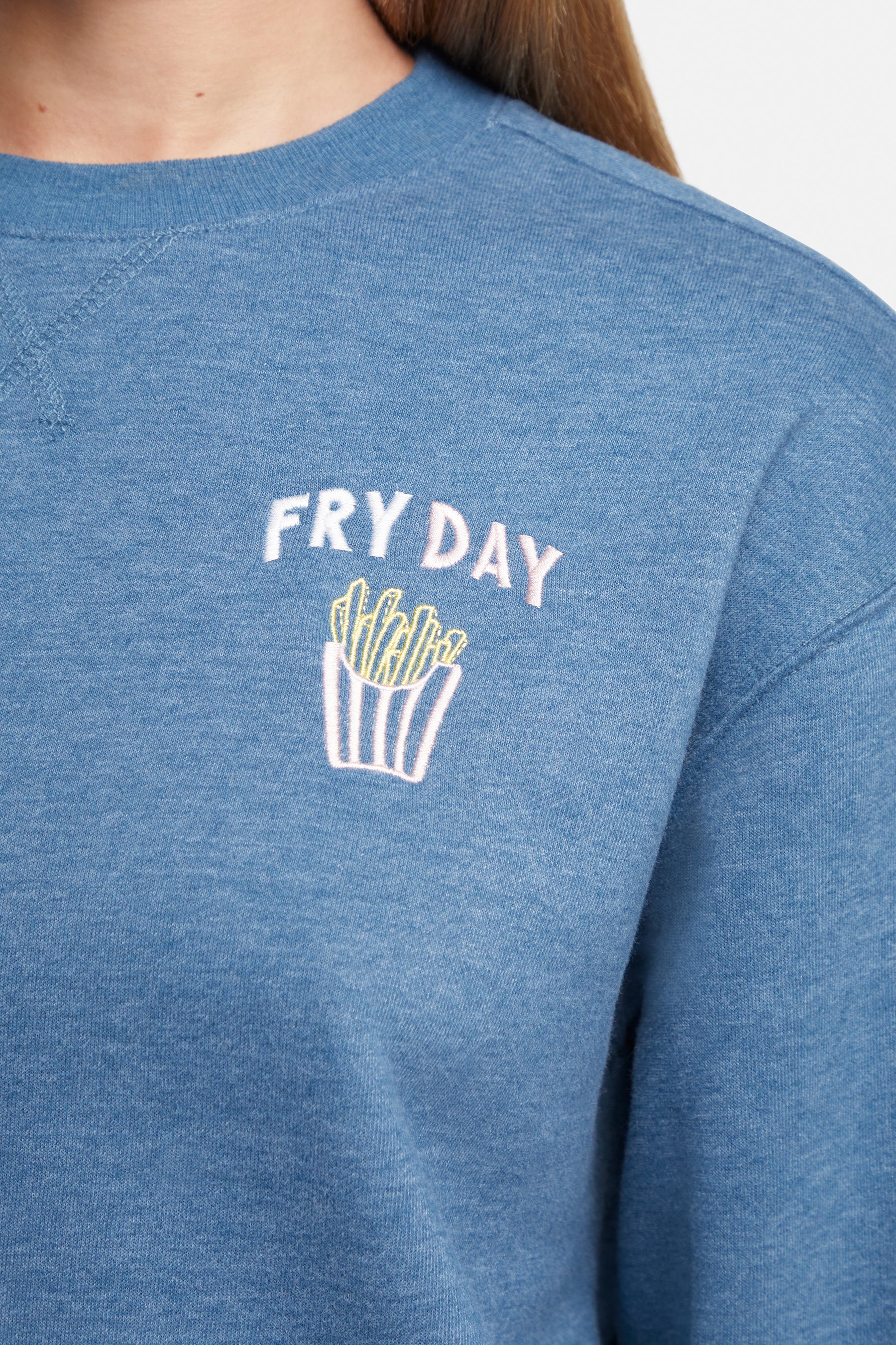 Close up of blue sweatshirt with &