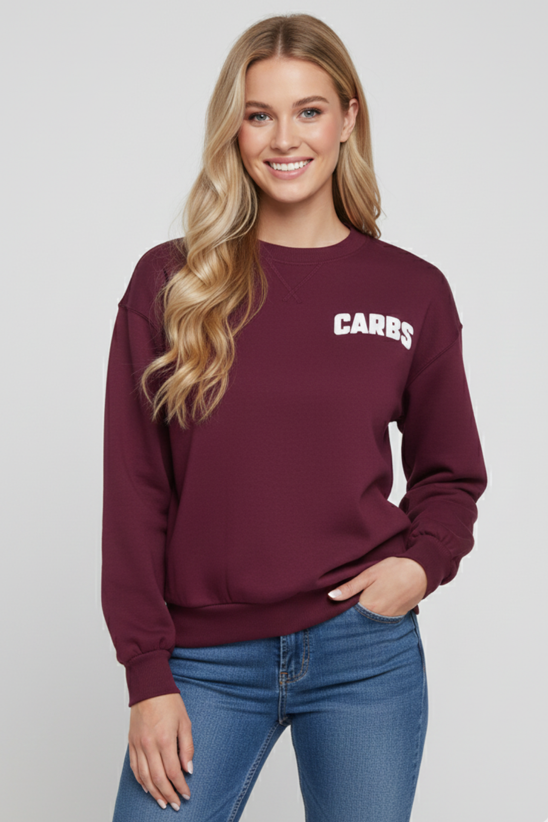 Woman wearing a maroon sweatshirt with &