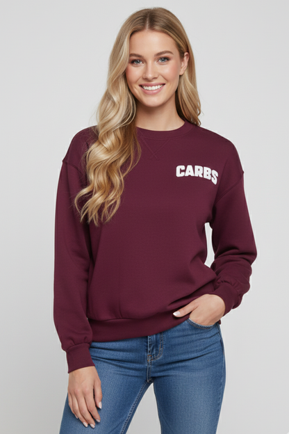 Woman wearing a maroon sweatshirt with &