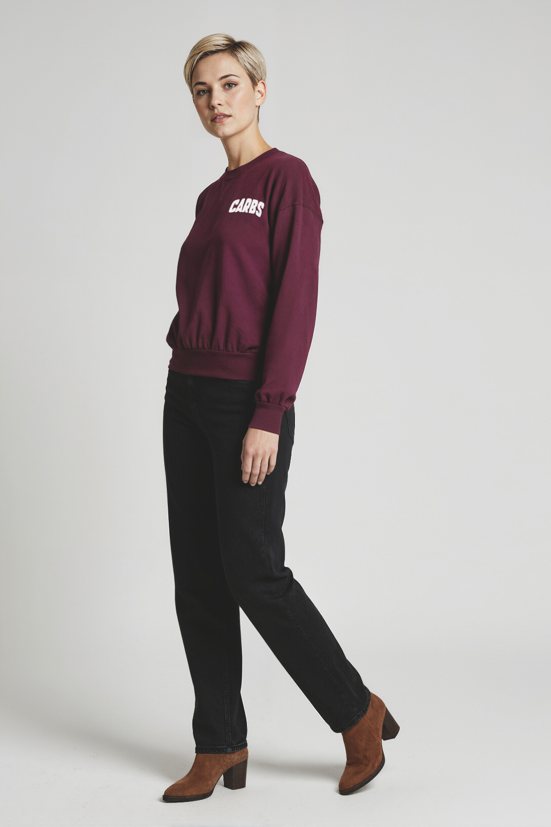 Woman wearing a burgundy sweatshirt with &