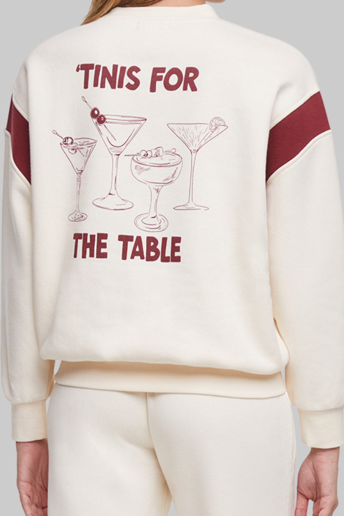 Close up of back of sweatshirt with 4 cocktails graphic and text &