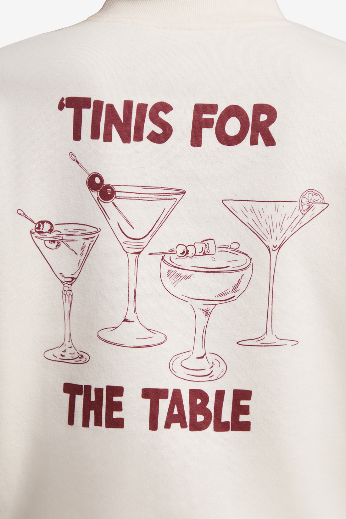 Close up of back of sweatshirt with 4 cocktails graphic and text &