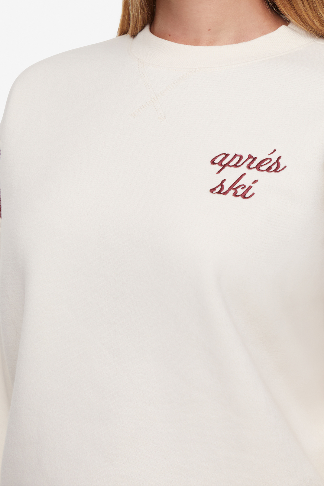 Close up of white sweatshirt with red &