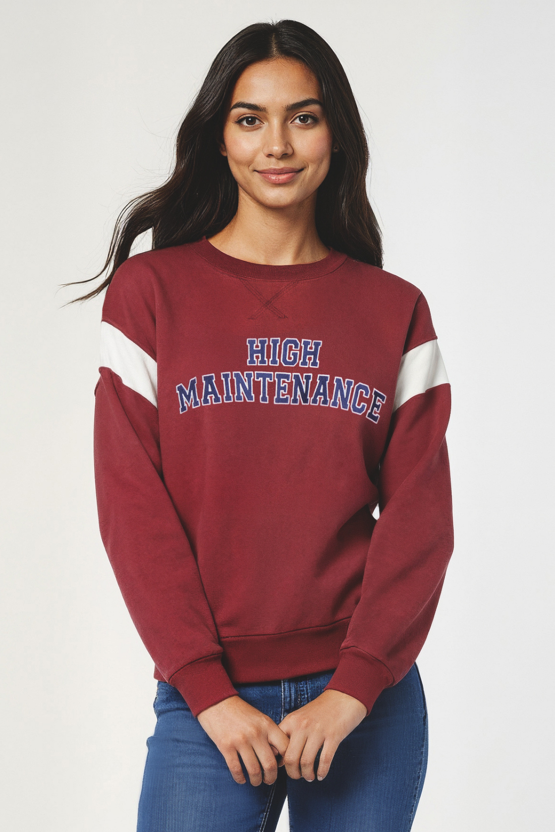 Woman wearing a maroon sweatshirt with &