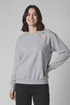 Woman wearing a gray sweatshirt with colorful &