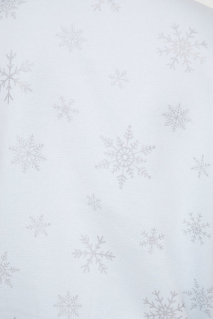 Close up of pattern of silver snowflakes on a light blue sweatshirt 