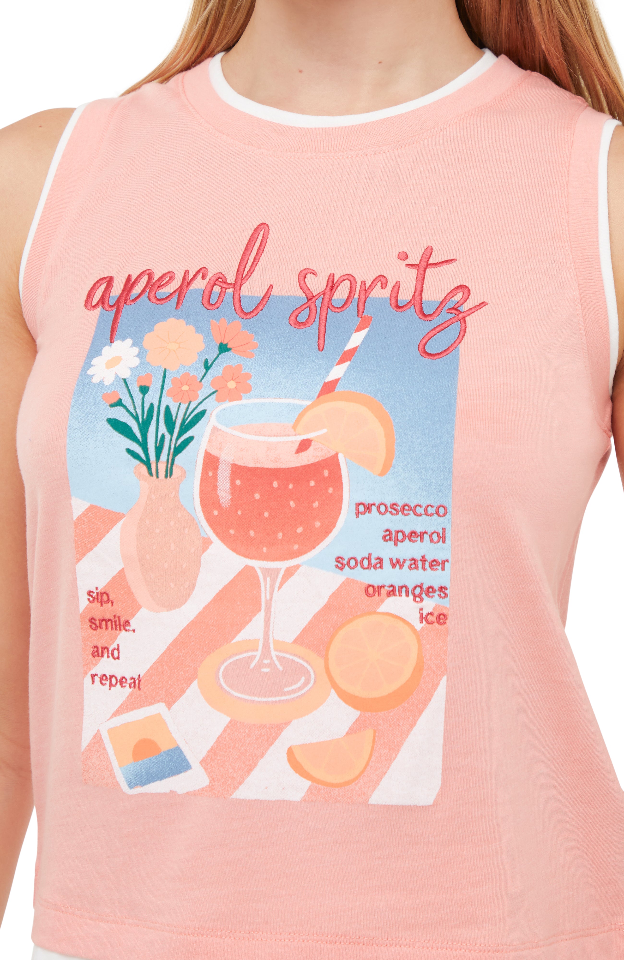 Close up of pink layered sleeveless shirt with aperol spritz and cocktail graphic design