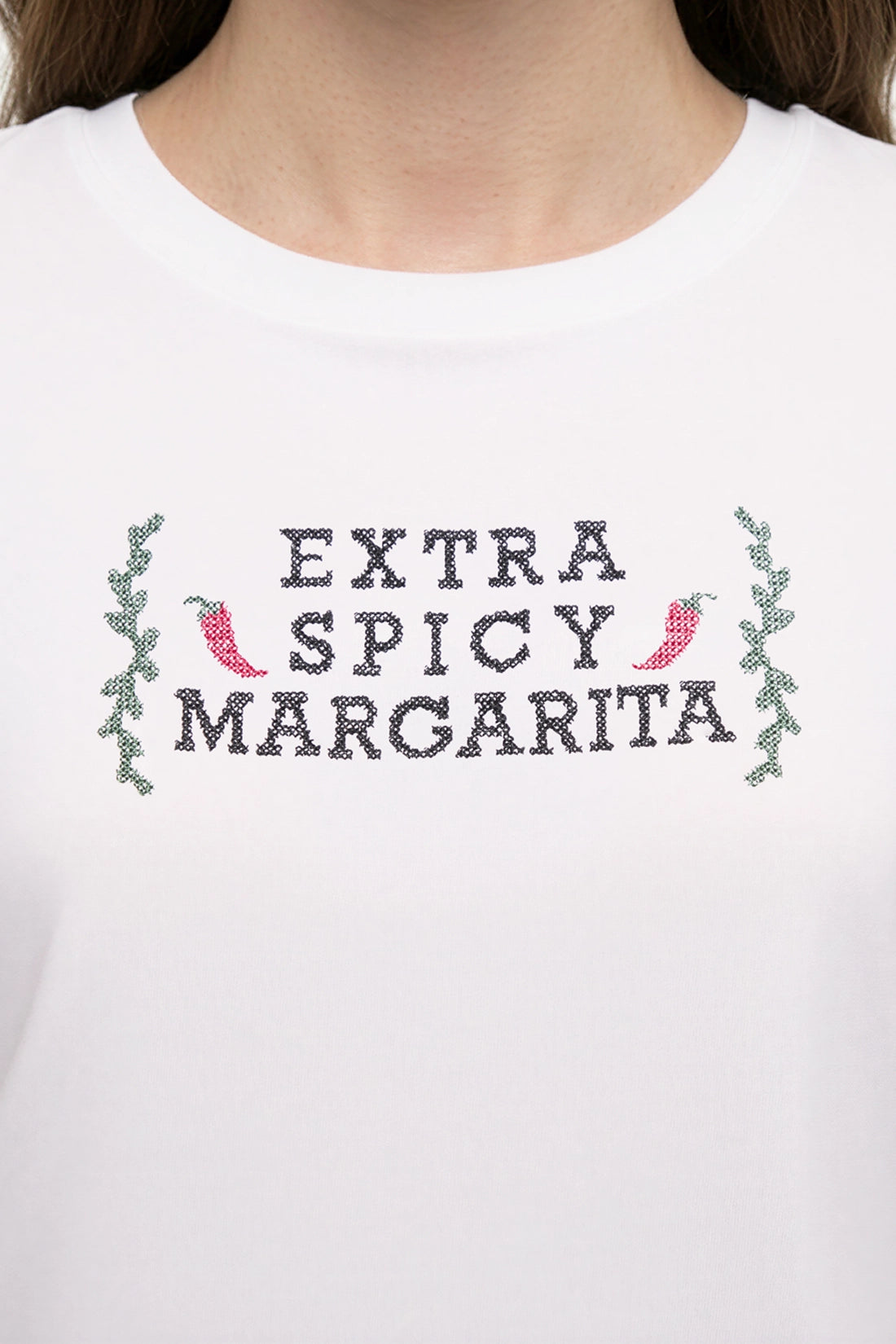 Close up front view of woman wearing a white t-shirt with &