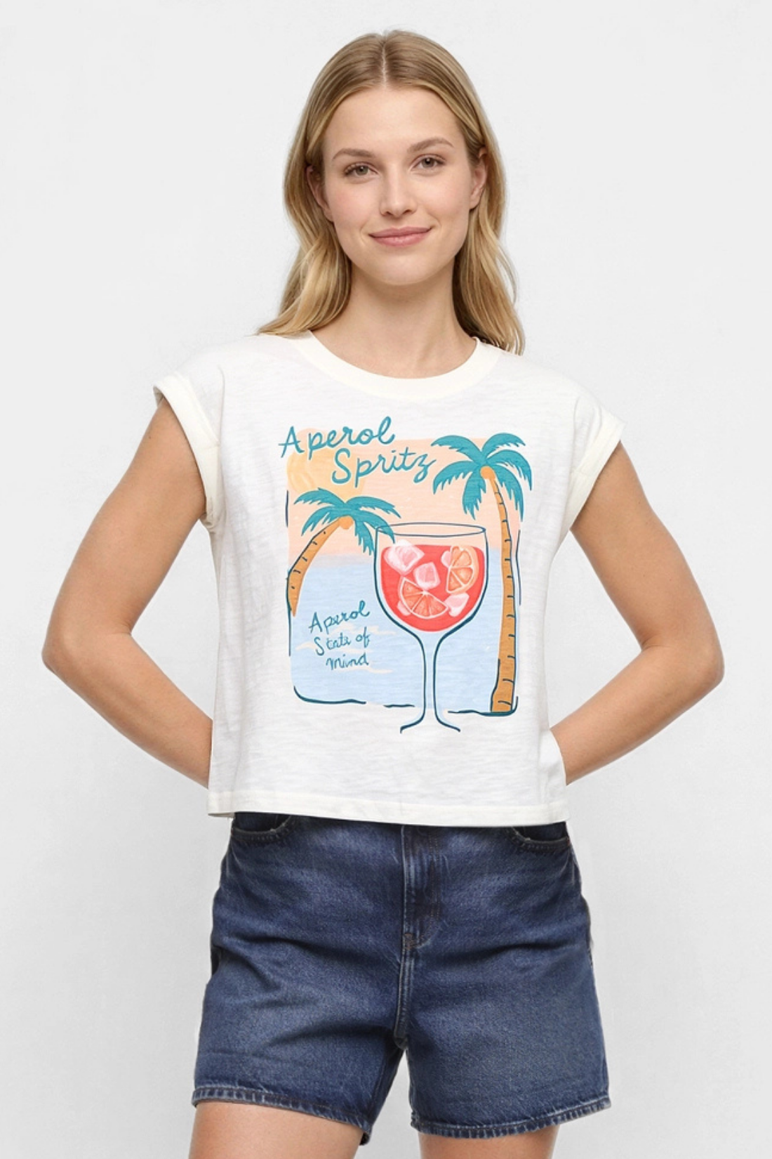 Front view of white t-shirt with "Aperol Spritz; Aperol State of Mind" text and graphic design featuring a cocktail and palm trees  on a white background. 
