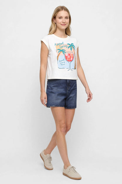 Side view of woman wearing white t-shirt with "Aperol Spritz; Aperol State of Mind" text and graphic design featuring a cocktail and palm trees and jean shorts on a white background. 