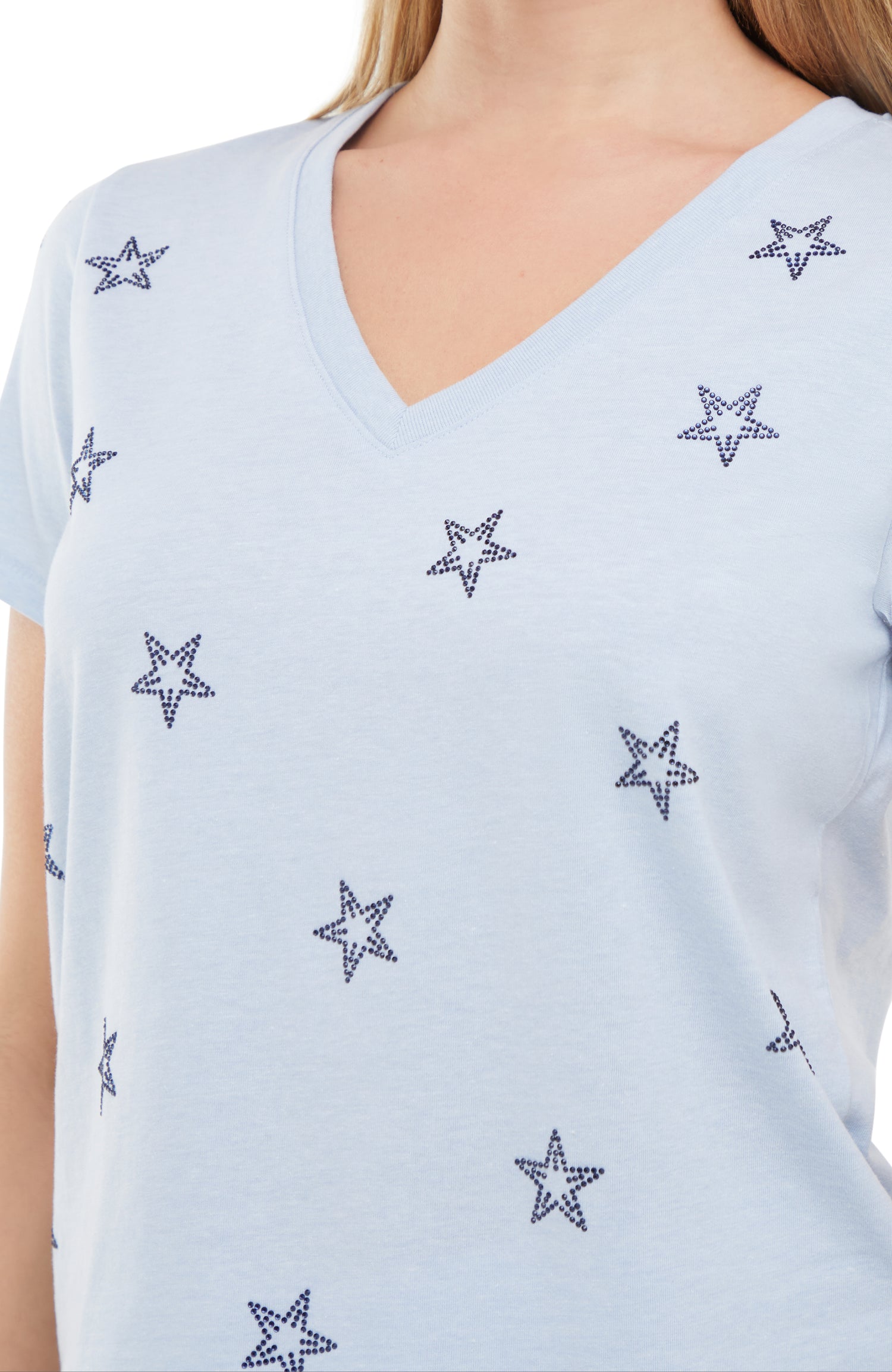 Close up of Light blue sleeveless top with rhinestone star patterns on a white background