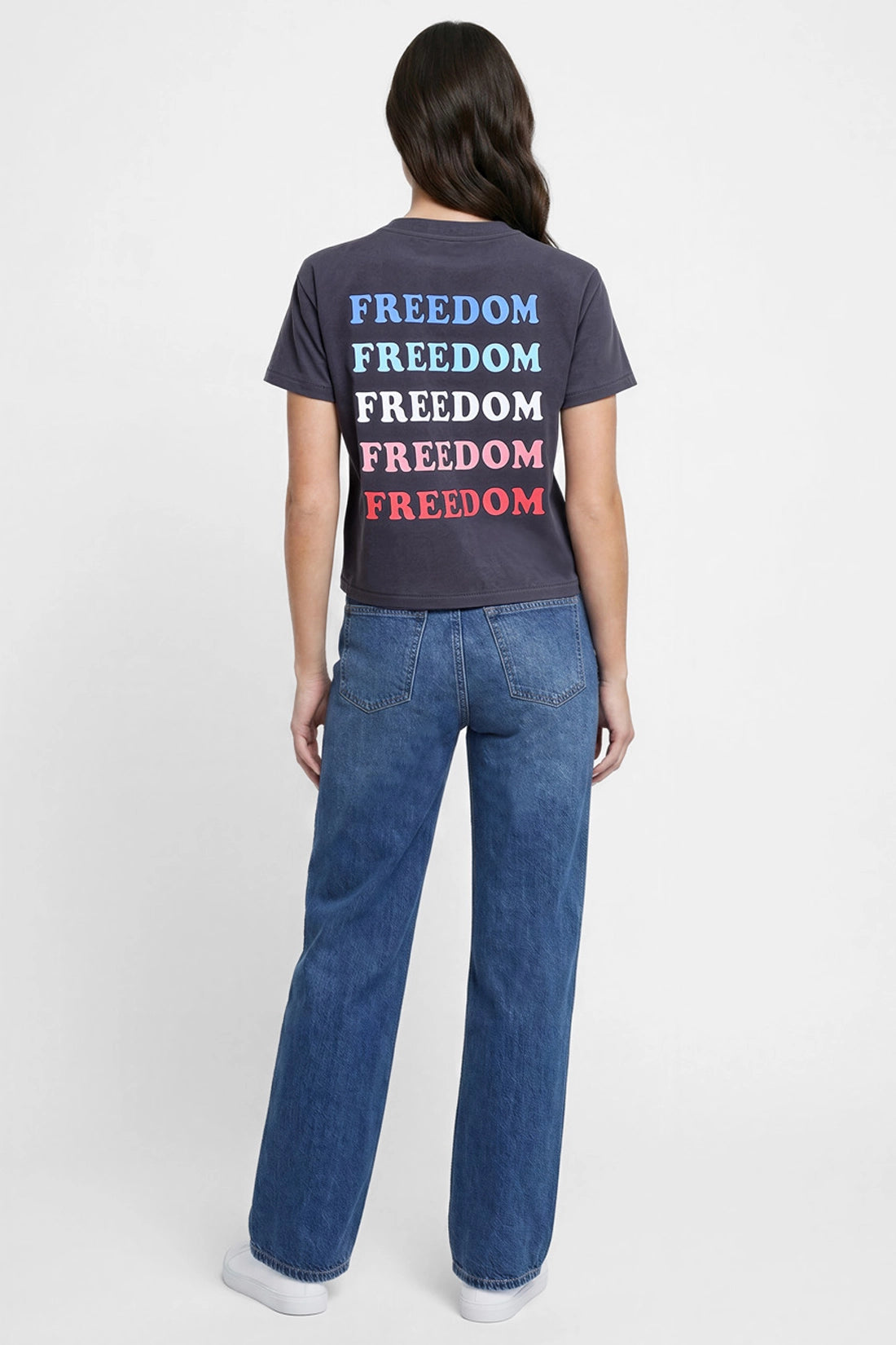 Back view of woman wearing a black t-shirt with &