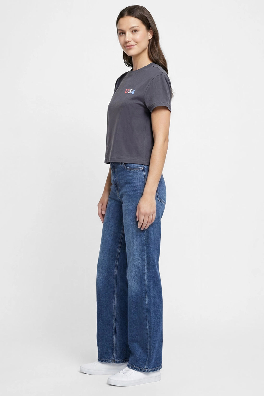 Side view of woman wearing a dark gray t-shirt with &