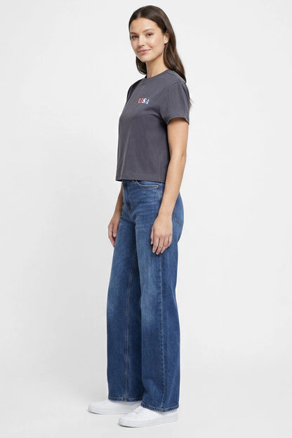 Side view of woman wearing a dark gray t-shirt with &