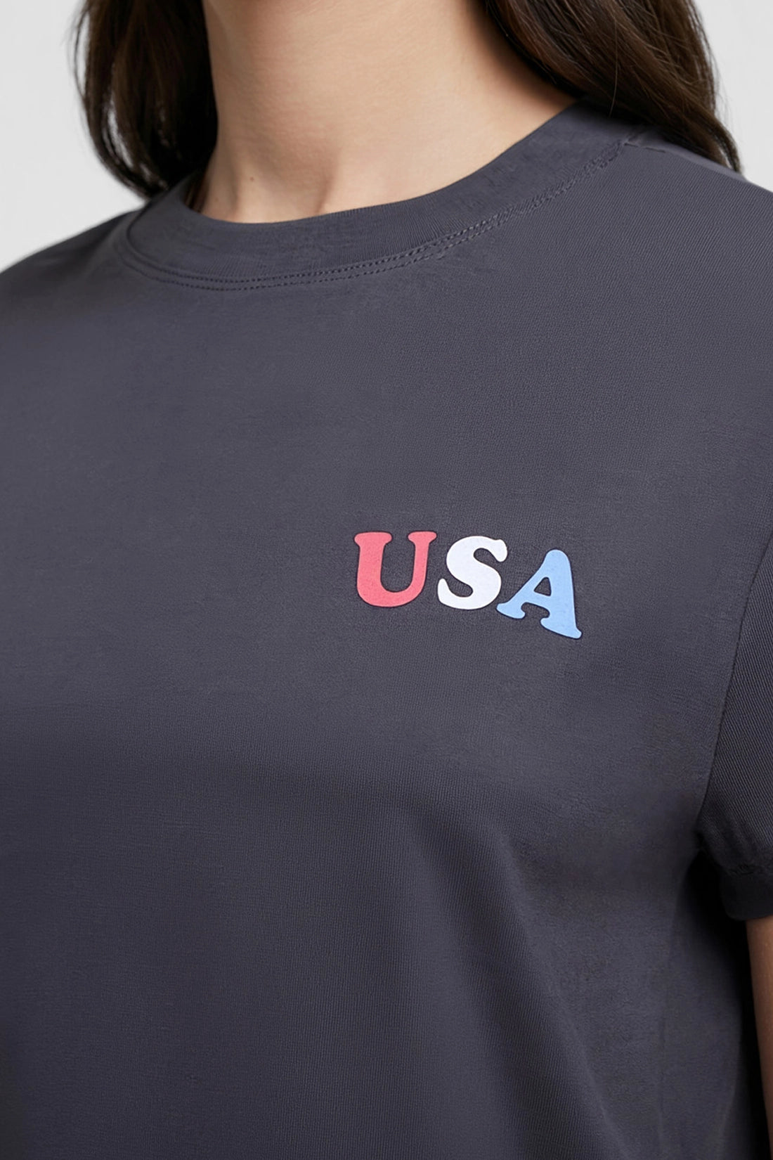 Close up of view of woman wearing a dark gray t-shirt with &