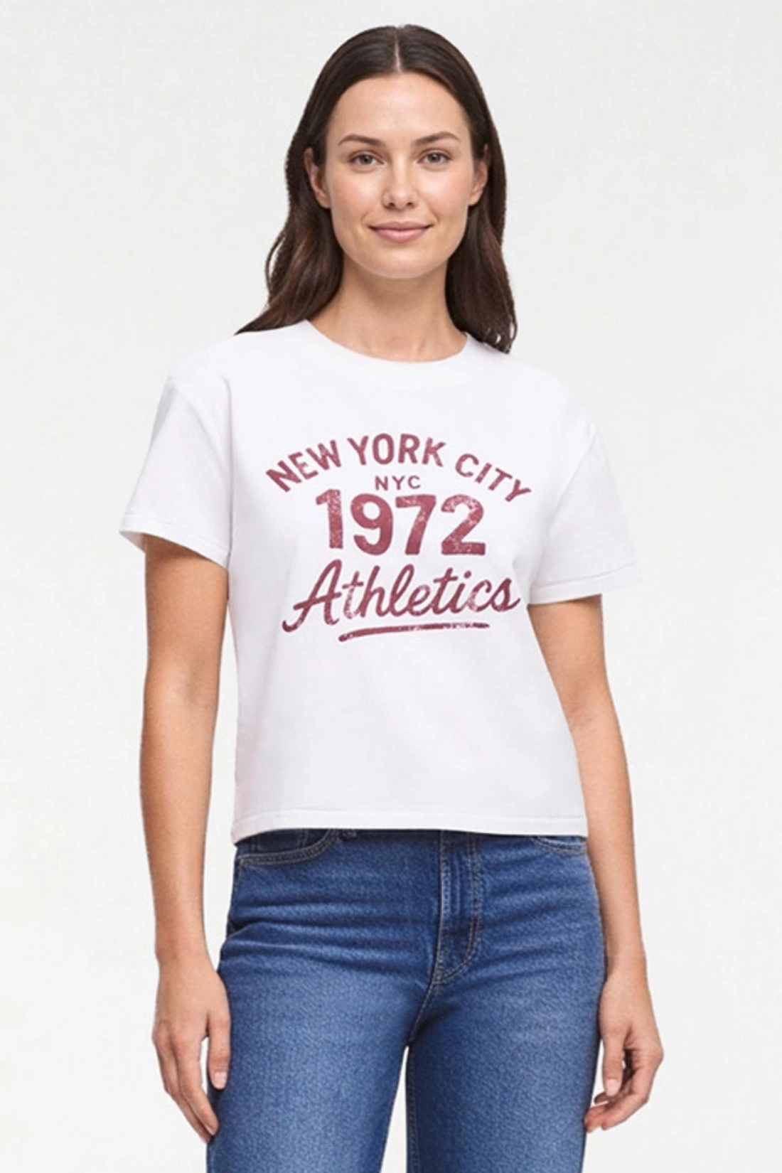 A woman modeling a white short-sleeve graphic T-shirt with red text reading &
