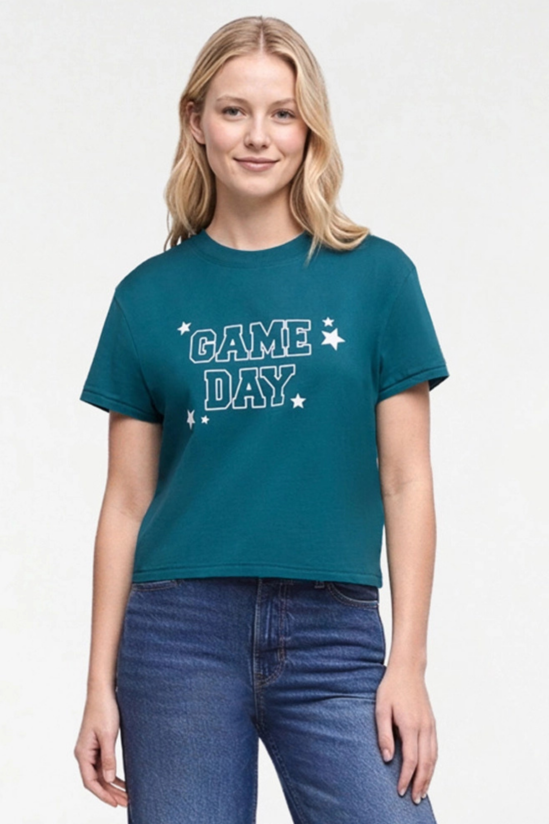 A woman wearing a teal cropped t-shirt with &