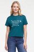 A woman wearing a teal cropped t-shirt with &