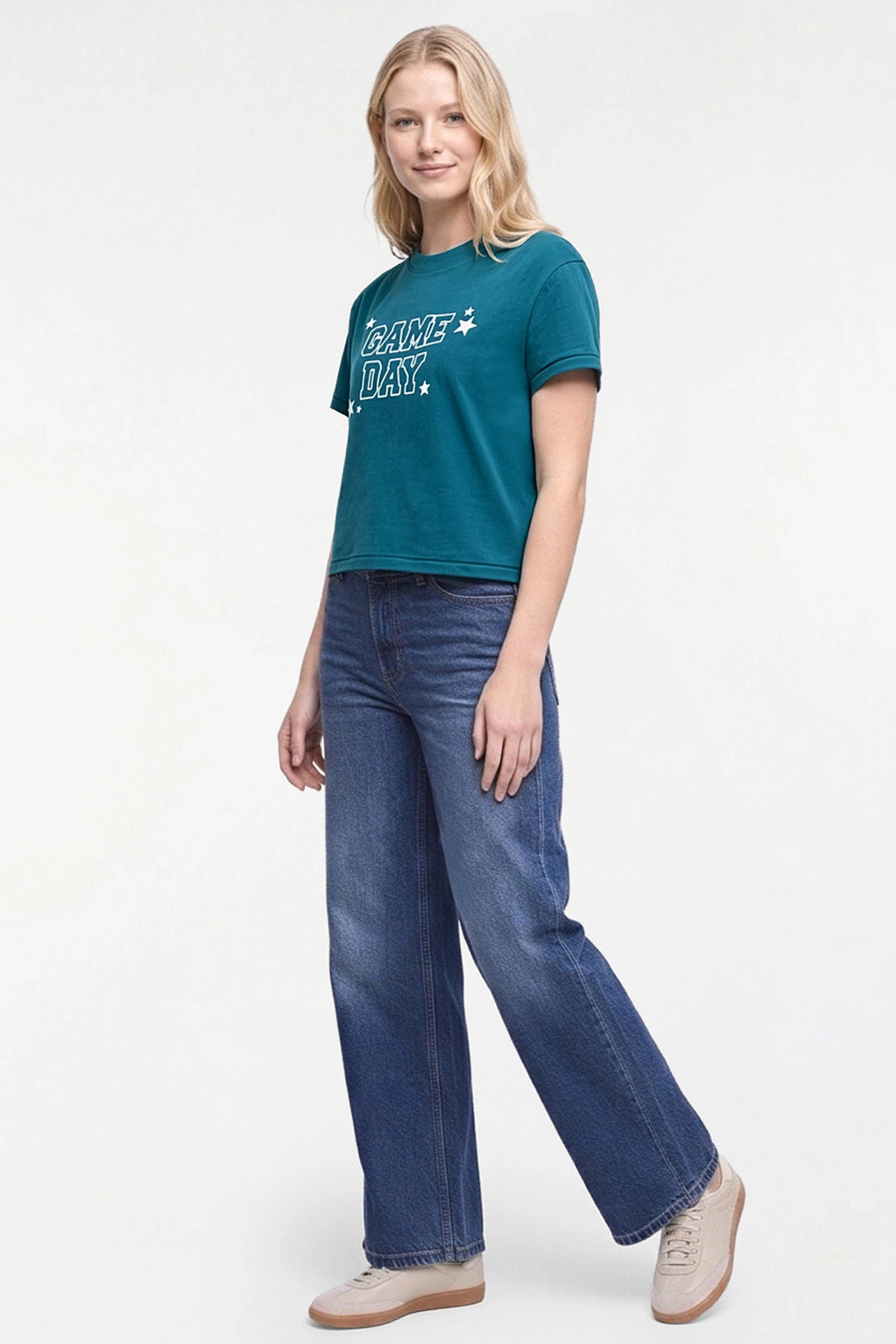 A woman modeling a teal short-sleeve graphic t-shirt with &