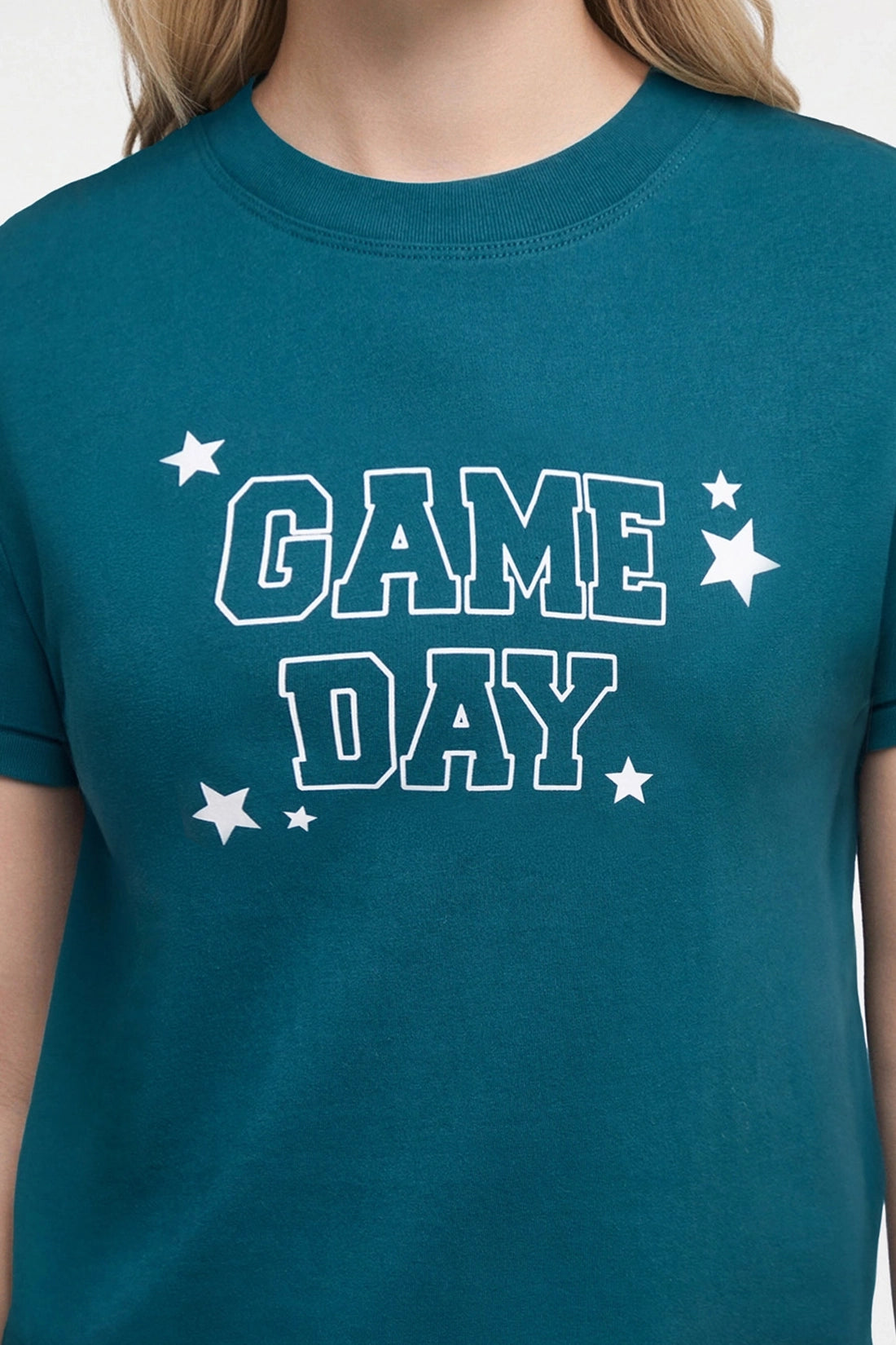 A close-up of a teal blue t-shirt featuring the words &