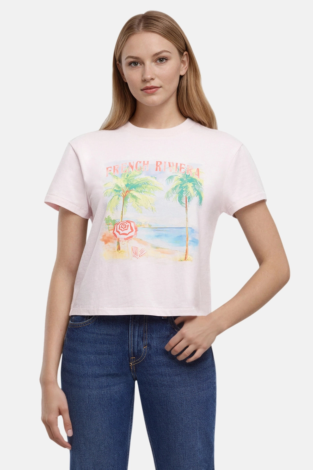 Woman wearing a pink t-shirt with a beach graphic and &