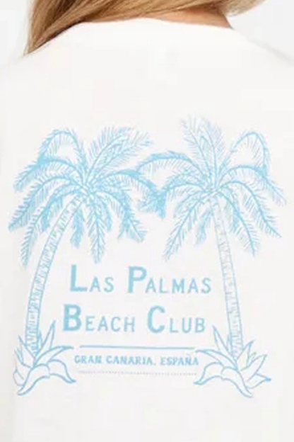 Close up back view of woman wearing a white t-shirt with "LAS PALMAS BEACH CLUB; GRAN CANARIA, ESPANA" text and graphic design featuring two palm trees on a white background. 