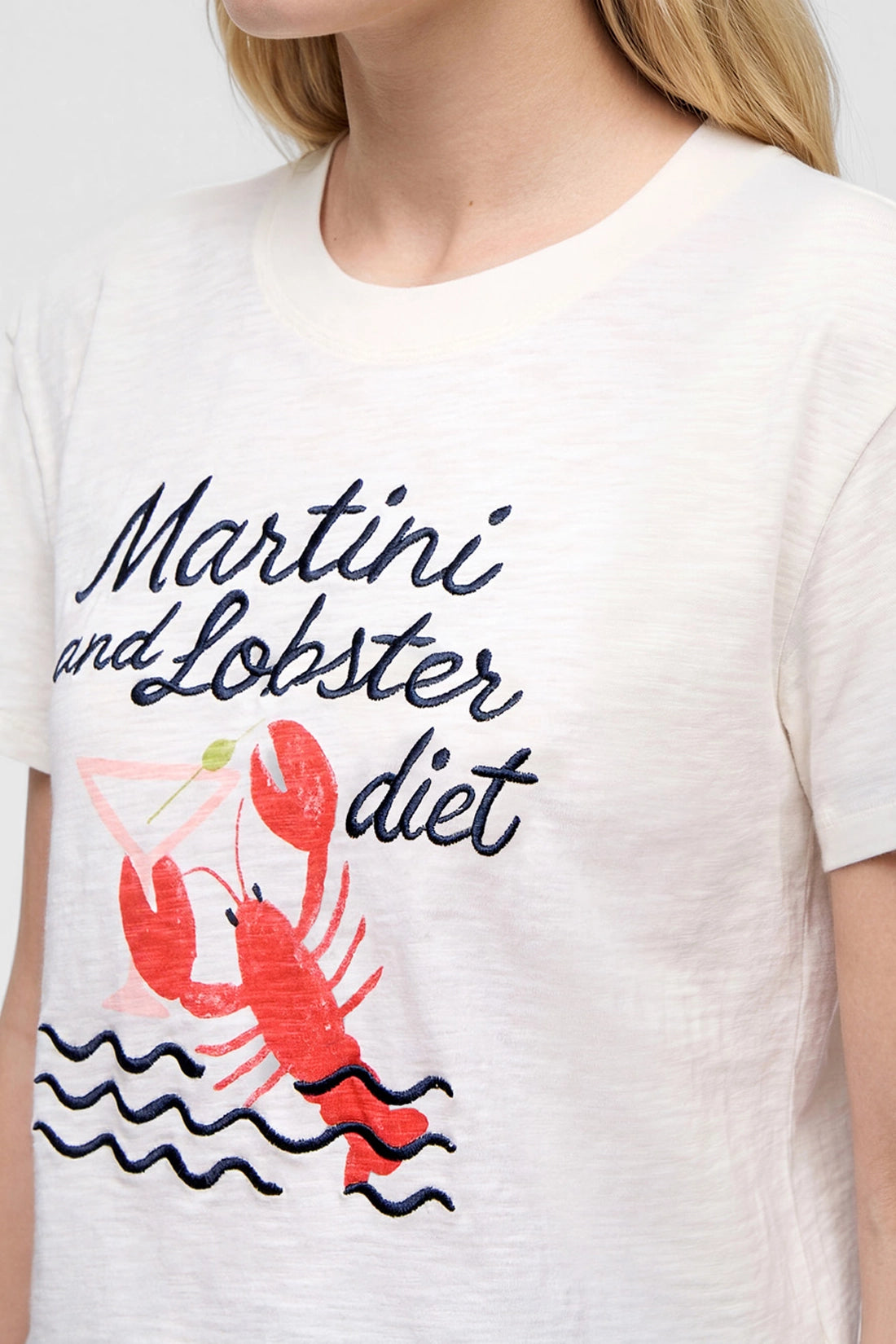 Close-up front view of woman wearing a white t-shirt with &
