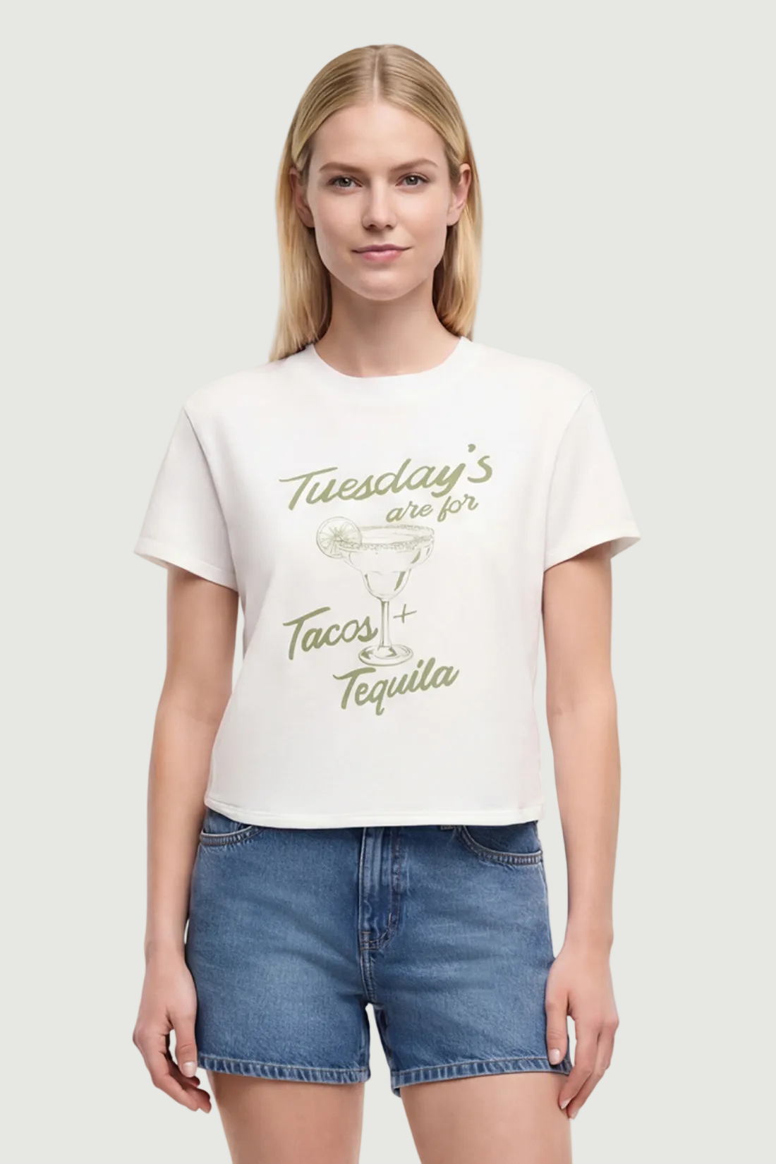 Front view of woman wearing a white t-shirt with a tequila cocktail glass graphic design and "Tuesday&