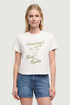 Front view of woman wearing a white t-shirt with a tequila cocktail glass graphic design and "Tuesday&