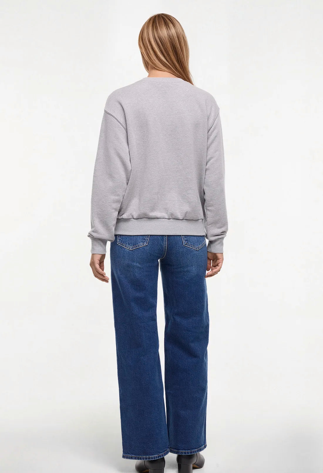 Back view woman wearing a heather gray sweatshirt with &