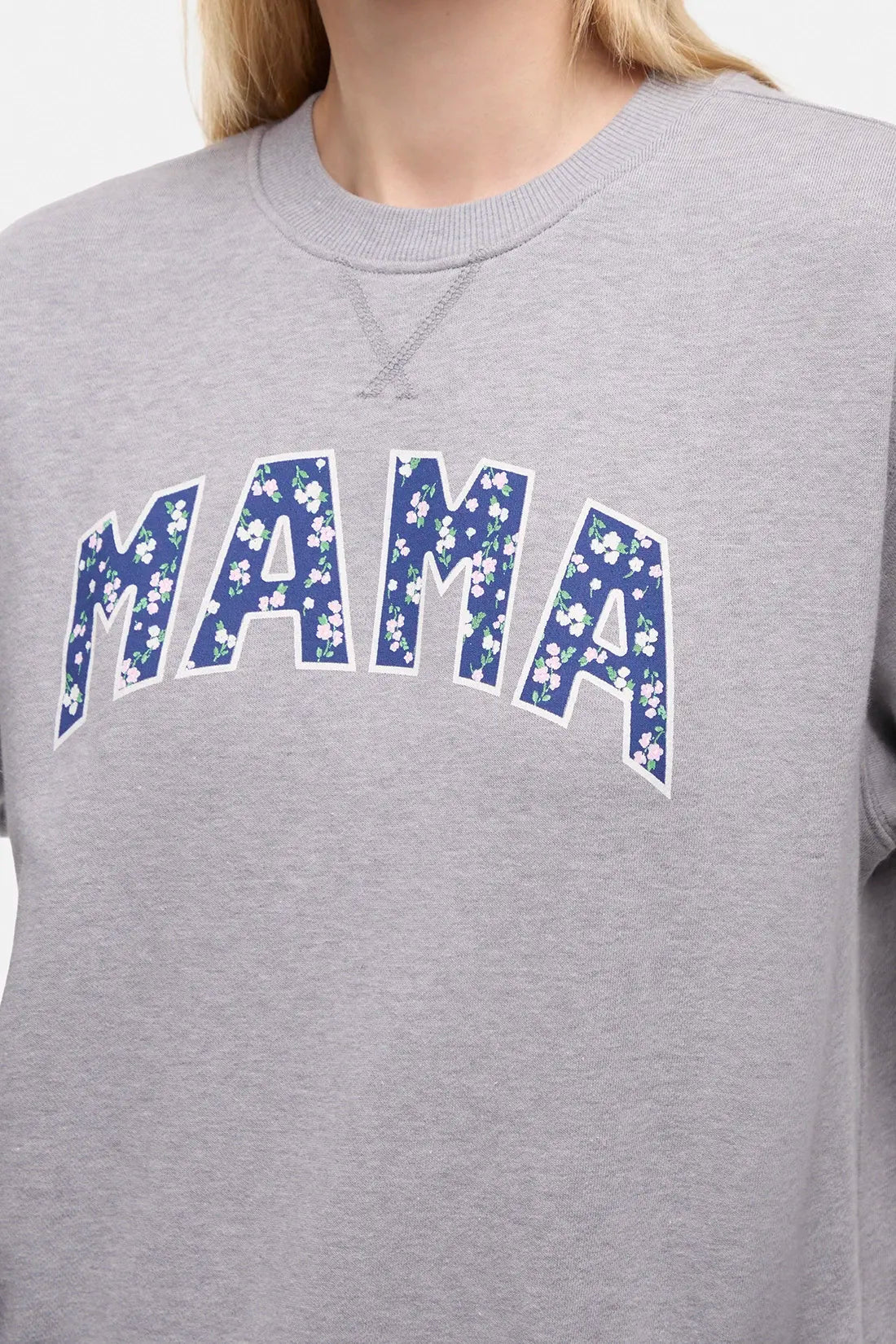 Front close up view of woman wearing a heather gray sweatshirt with &