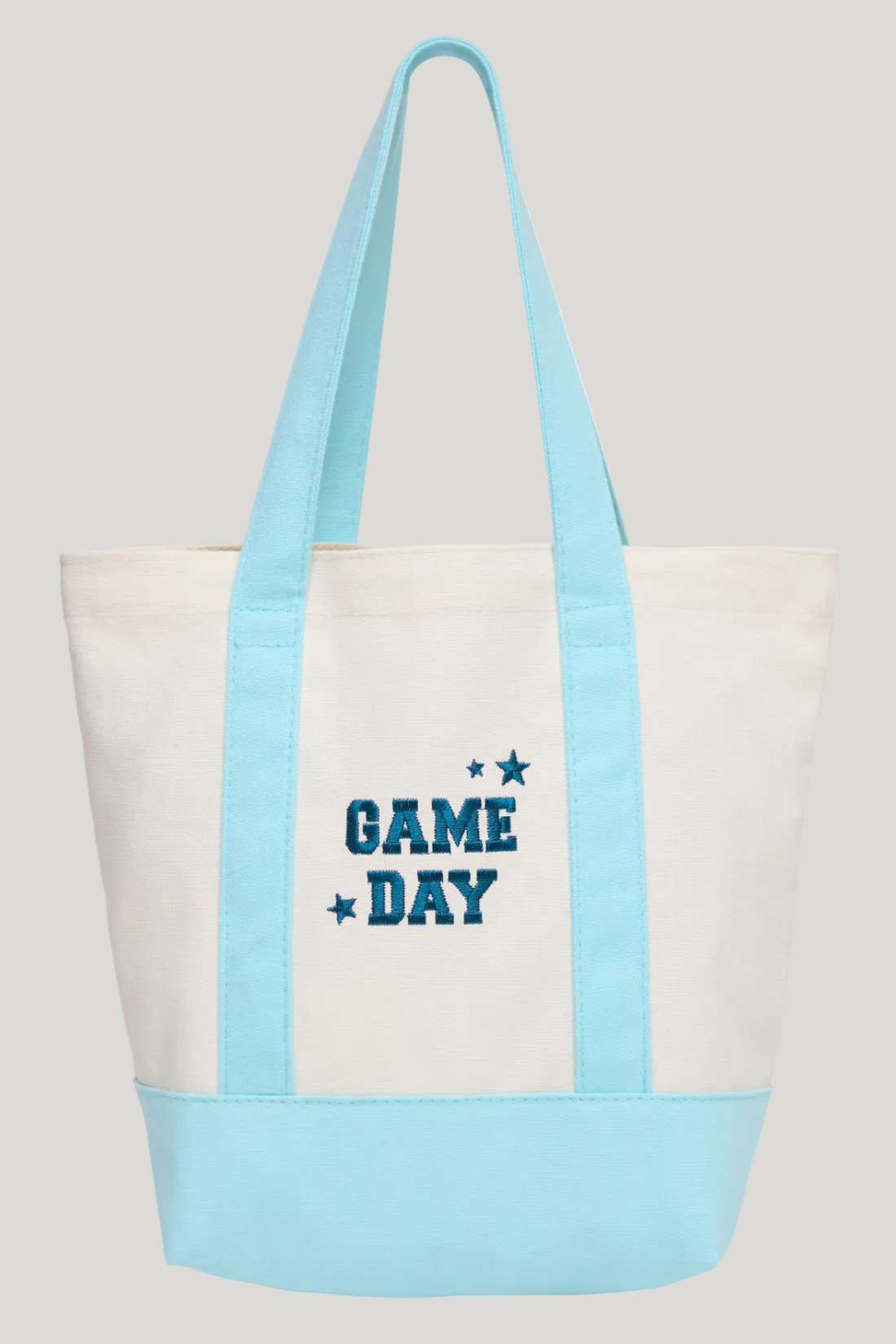 A canvas tote bag with a cream body, light blue handles and bottom panel, and &