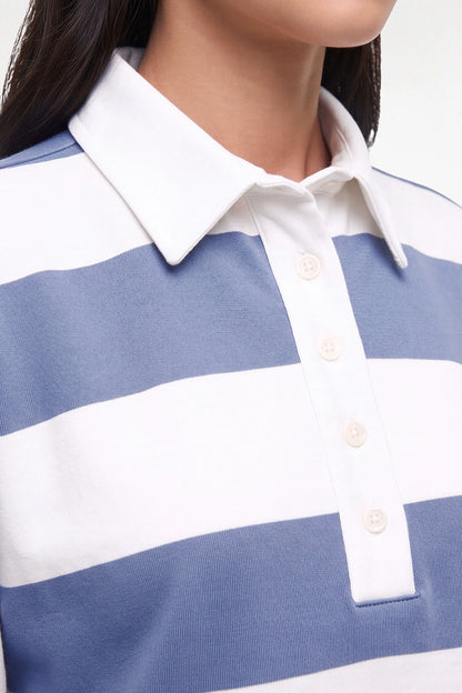 Close-up of a person wearing a blue and white horizontally striped polo shirt with a white collar and three visible buttons. 