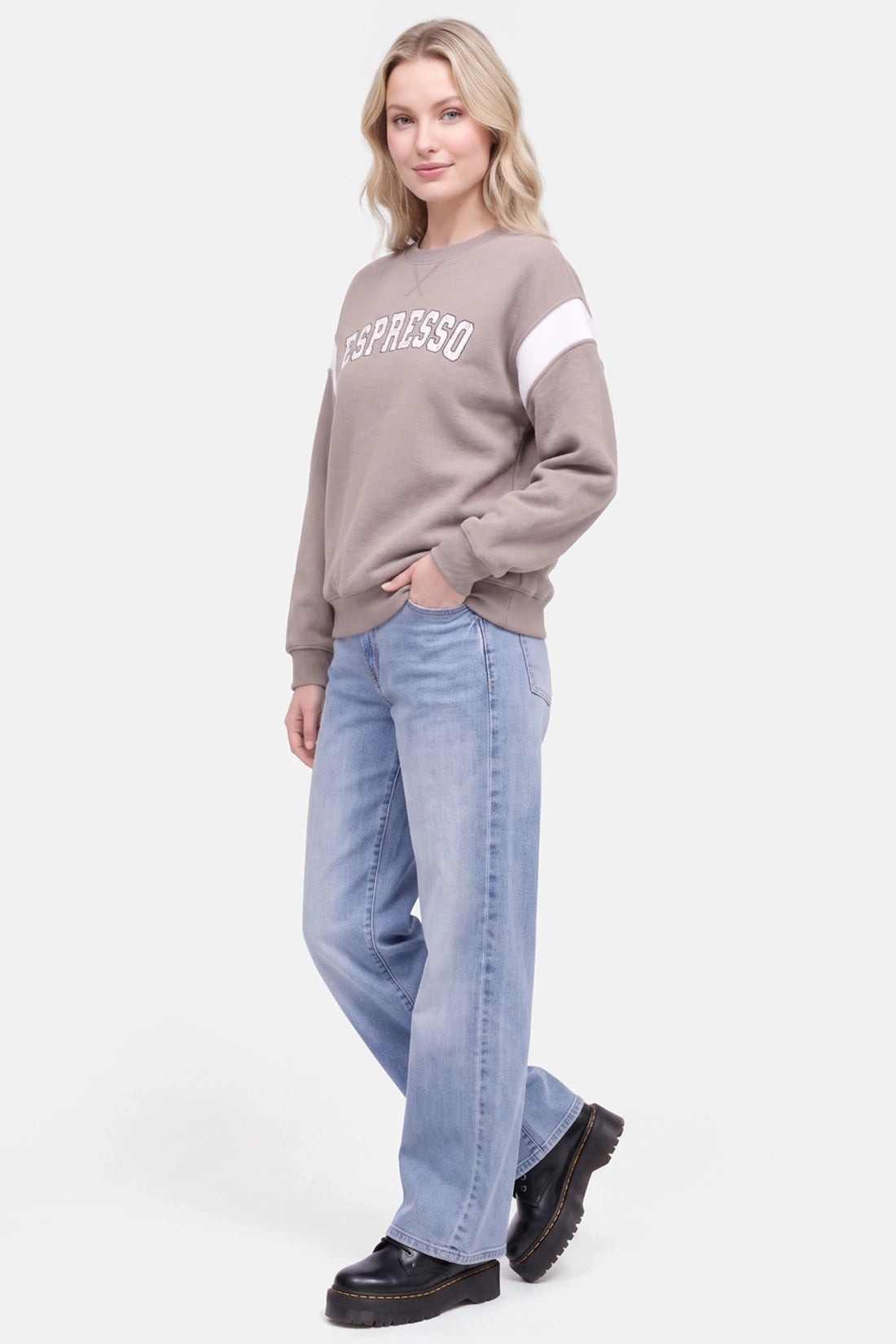 A woman modeling a taupe crewneck sweatshirt with white &