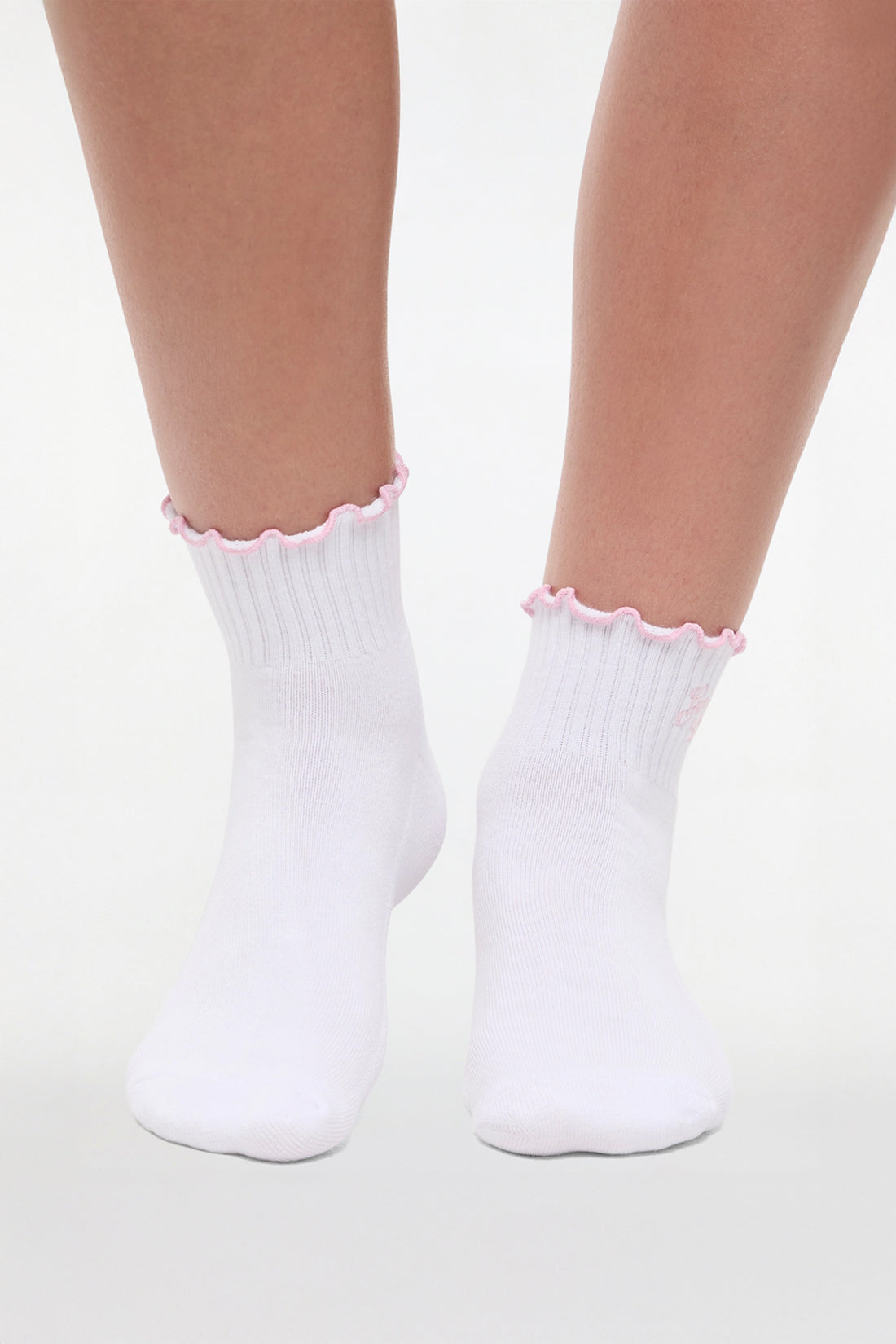 Front view of white socks with lilac ruffled trim and &