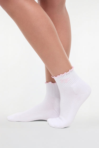 Side view of white socks with lilac trim and &