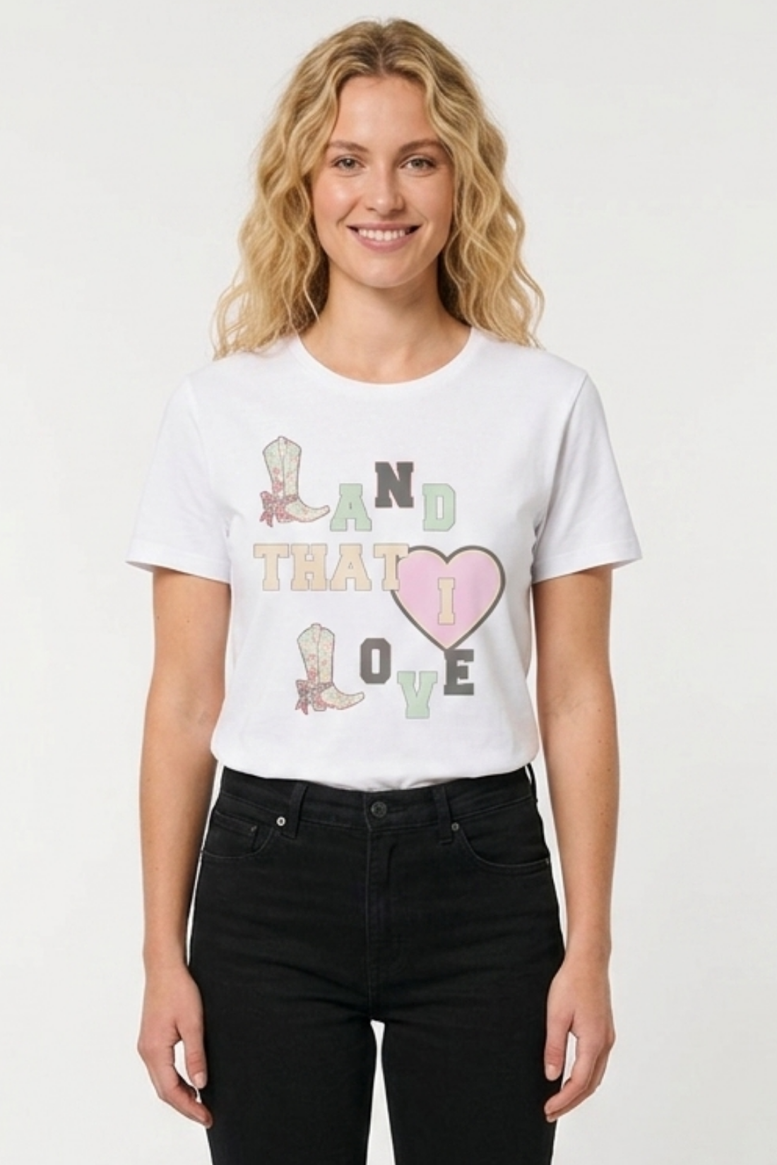 Woman wearing a white t-shirt with graphic design on a plain background