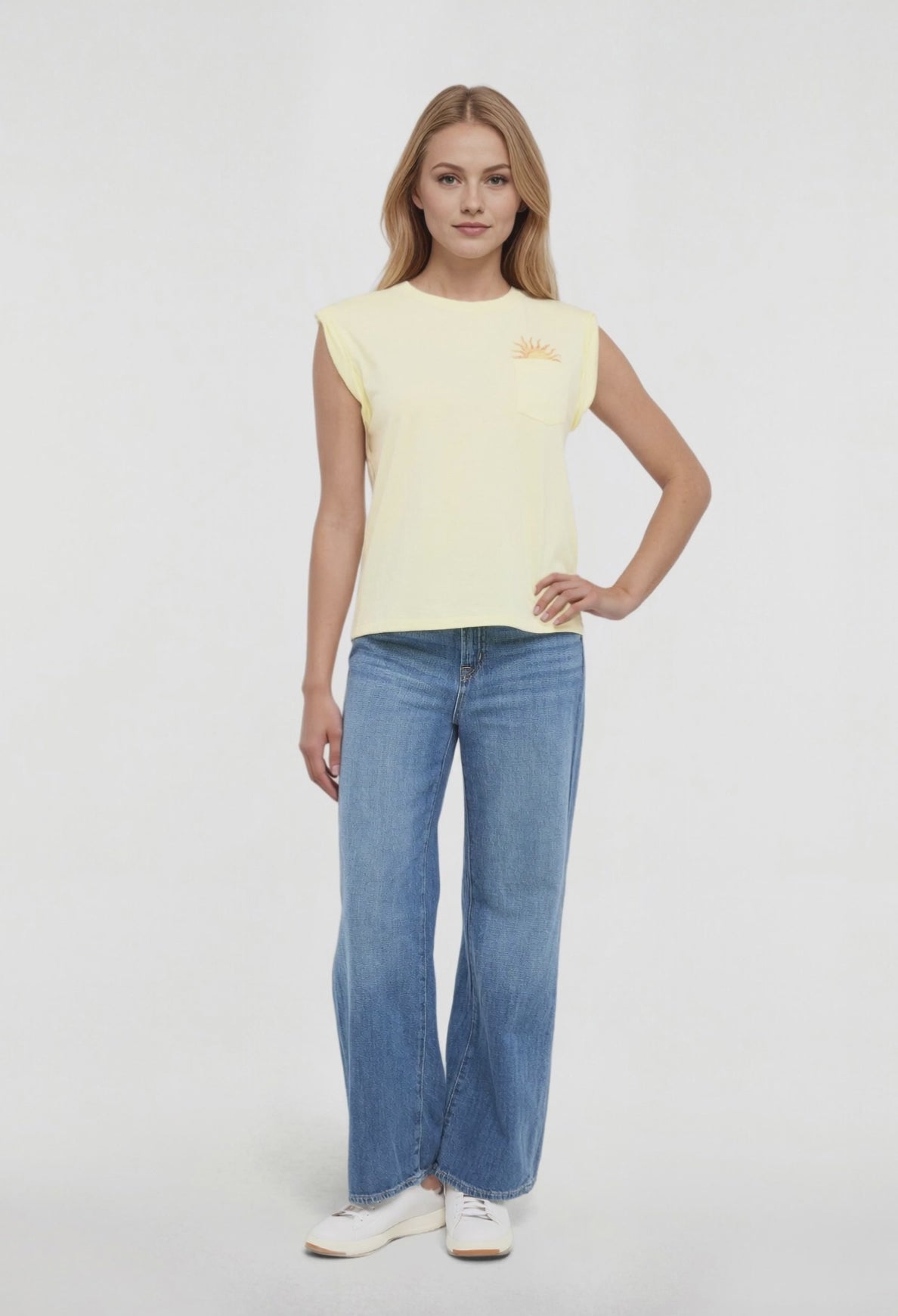 Video view of woman wearing a yellow sleeveless shirt with a sun and wave design and &