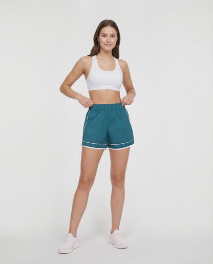 Video view of teal green athletic shorts with white trim worn by a woman on a white background. 