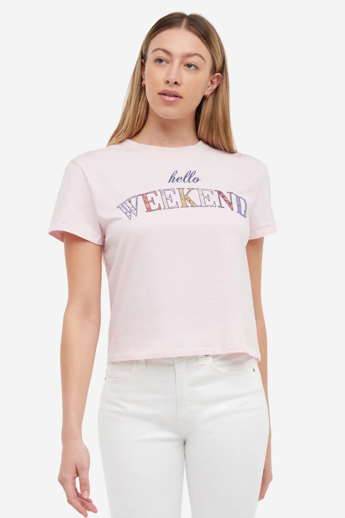 Front view of woman wearing a light pink t-shirt with colorful &